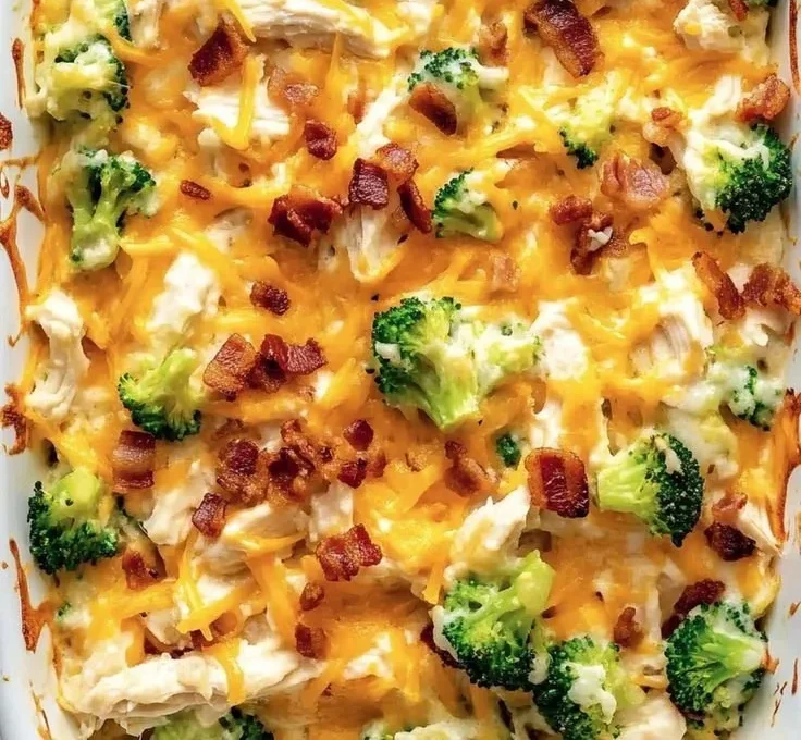 Creamy low carb chicken casserole topped with cheese and herbs in a baking dish