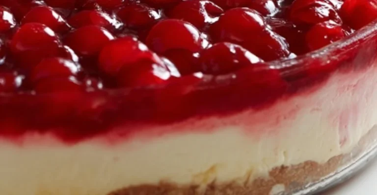 Delicious no-bake cherry cheesecake dessert topped with fresh cherries.