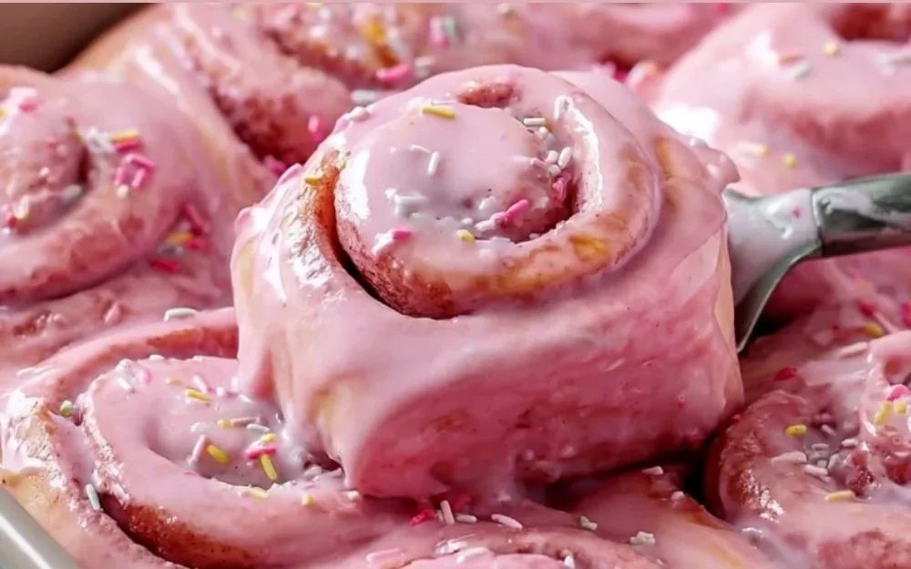 Pink Velvet Cinnamon Rolls topped with cream cheese frosting