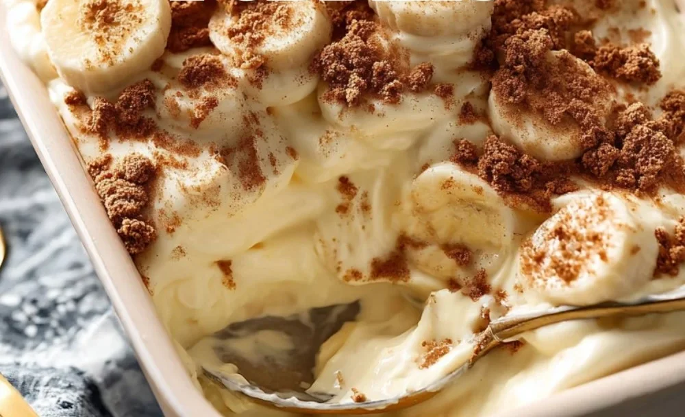 Creamy Biscoff banana pudding served in a glass with banana slices and Biscoff cookies