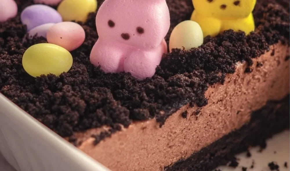 Easter Dirt Cake decorated with chocolate crumbs and colorful candies
