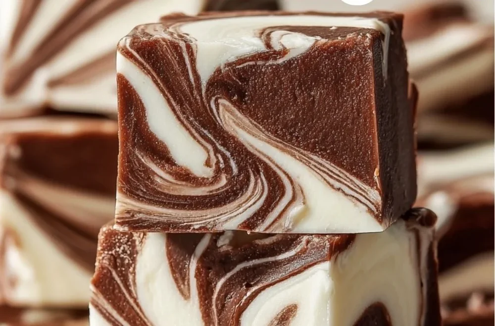 Delicious Marshmallow Swirl Fudge drizzled with chocolate and topped with marshmallows