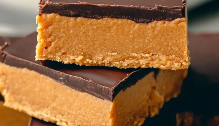 No-bake chocolate topped peanut butter bars stacked on a white plate