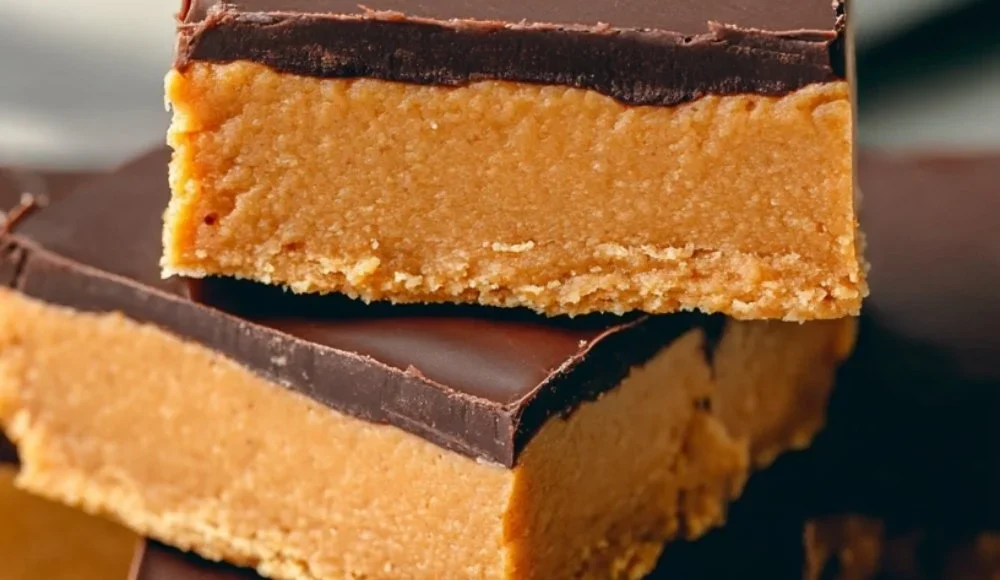 No-bake chocolate topped peanut butter bars stacked on a white plate