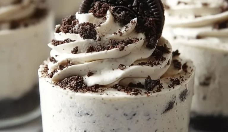 No-Bake Oreo Cheesecake topped with crushed Oreos and chocolate drizzle.