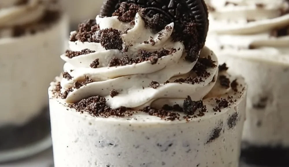 No-Bake Oreo Cheesecake topped with crushed Oreos and chocolate drizzle.
