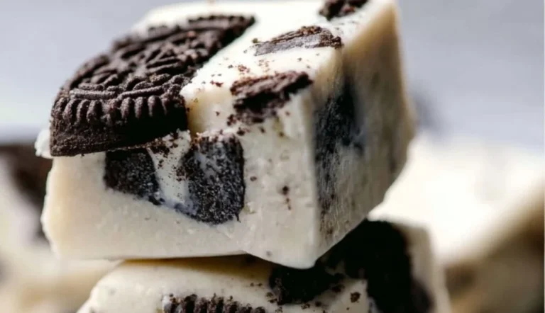 Decadent Oreo Fudge dessert topped with Oreo cookies and chocolate drizzle.